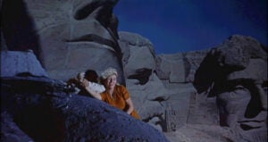 Film still showing Eva Marie Saint climbing across the Mount Rushmore monument in North by Northwest