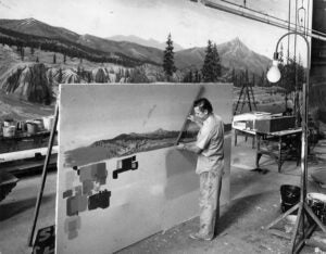Ronald Verne Strang painting a scenic backdrop in a studio