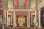 Grand foyer with staircase, columns, statues, and balcony