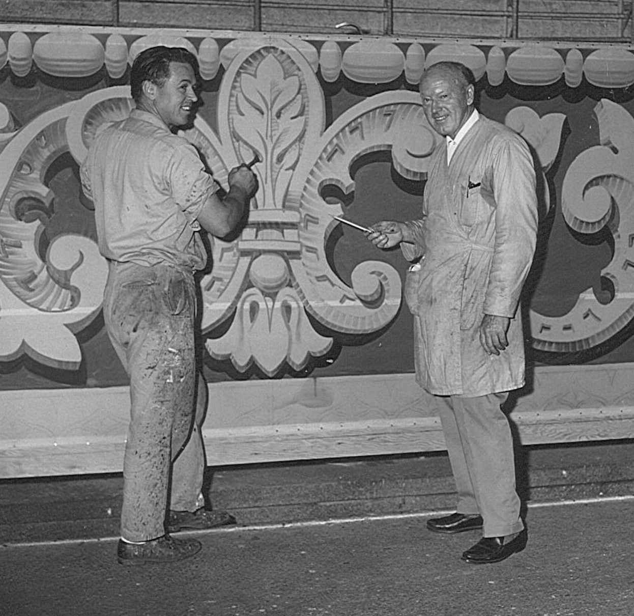 Scenic artists Verne Strang and son Ron Strang at paint frame at Warner Bros. 