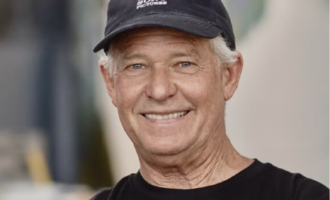 Color portrait photograph of scenic artist Don McDonald wearing a Sony Pictures cap