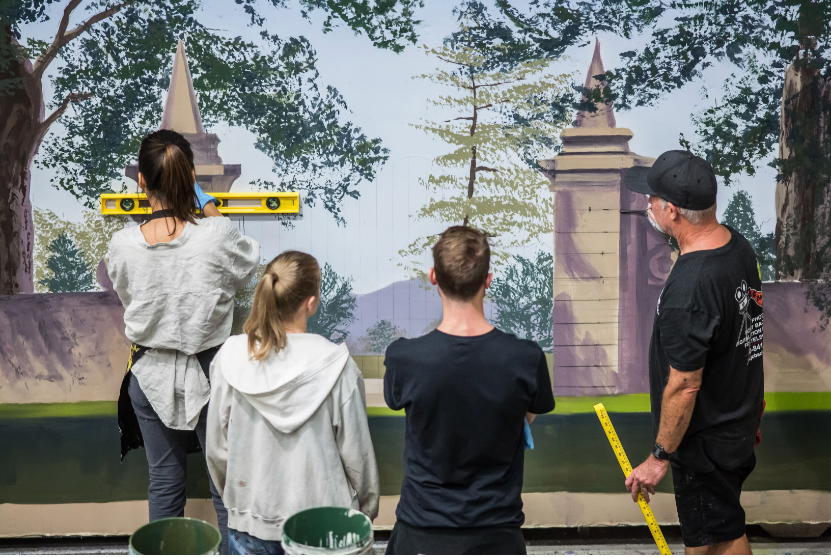 Guest Artist Donald MacDonald and UT scenic art students recreating a copy of a backdrop from the 1965 film, The Sound of Music. 