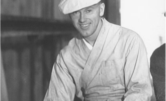 Black-and-white portrait photograph of scenic artist Verne Edward Strang in a studio setting