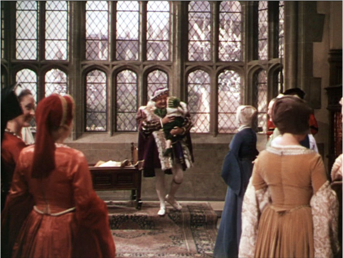 Scene from Young Bess (1953) showing performers in a Tudor interior set with leaded-glass windows
