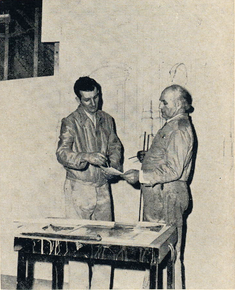 Supervisor of the new scenic art staff is John Coakley, left. Here he discusses a perspective problem with Peter Stetzenko, veteran of 35 years in the field of scenic art.
